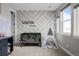 Bright bedroom featuring a crib, teepee, and stylish geometric accent wall with customized name art at 6737 S White Crow Way, Aurora, CO 80016