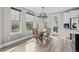 Cozy dining area with bright windows, wood table, and modern lighting fixture near the kitchen at 6737 S White Crow Way, Aurora, CO 80016