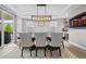 Dining room features large table, elegant chandelier, and stylish decor for memorable gatherings at 6737 S White Crow Way, Aurora, CO 80016