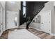 Elegant entryway with black spiral staircase, wood floors, and a bright, airy feel at 6737 S White Crow Way, Aurora, CO 80016