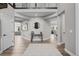 Open entryway with wood floors, neutral colors, a decorative table and mirror at 6737 S White Crow Way, Aurora, CO 80016