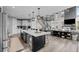 Bright open-concept kitchen features large island, stainless steel appliances, and flows into the living area at 6737 S White Crow Way, Aurora, CO 80016