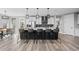 Modern kitchen with sleek countertops, stylish pendant lighting, and ample seating at the island at 6737 S White Crow Way, Aurora, CO 80016