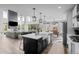 Spacious open kitchen with large island, stainless steel appliances, and seamless flow into the living space at 6737 S White Crow Way, Aurora, CO 80016