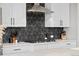 Modern kitchen features stainless steel appliances, gas range, quartz countertops, and black geometric backsplash at 6737 S White Crow Way, Aurora, CO 80016