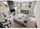 Bright, open-concept living room with hardwood floors, fireplace, high ceilings, and a large sectional sofa at 6737 S White Crow Way, Aurora, CO 80016