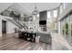 Bright, open living room with a large fireplace, high ceilings, and walls of windows at 6737 S White Crow Way, Aurora, CO 80016