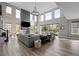 Spacious living room featuring high ceilings, fireplace, and large windows with plenty of natural light at 6737 S White Crow Way, Aurora, CO 80016