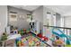 Cozy playroom with an alphabet rug, plenty of toys, and natural light from the windows at 6737 S White Crow Way, Aurora, CO 80016