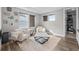 Relaxing sitting room with neutral colors, comfortable armchairs, and ample natural light at 6737 S White Crow Way, Aurora, CO 80016