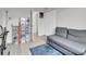 Bedroom featuring a gray sofa, shoe display, and closet space at 3432 S Locust St # A, Denver, CO 80222