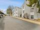 Street view of condos featuring light gray siding, neat landscaping, and convenient carport parking at 3432 S Locust St # A, Denver, CO 80222