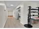 Hallway with closeted stacked washer dryer unit and built-in shelves at 3432 S Locust St # A, Denver, CO 80222