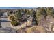 Aerial view of a beautiful home nestled among mature trees and meticulously landscaped grounds at 8223 Kincross Way, Boulder, CO 80301