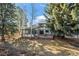 Expansive backyard featuring a deck, lush greenery, and mature trees at 8223 Kincross Way, Boulder, CO 80301