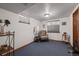 Cozy basement with a comfortable armchair, neutral walls, and soft blue carpeting at 8223 Kincross Way, Boulder, CO 80301