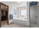 Bathroom with soaking tub, shower, and large window for natural light at 8223 Kincross Way, Boulder, CO 80301