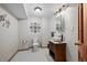 Stylish bathroom featuring a unique vessel sink, decorative mirror, and black and white patterned flooring at 8223 Kincross Way, Boulder, CO 80301