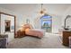 Bright bedroom with vaulted ceiling, fan, and sliding door to balcony at 8223 Kincross Way, Boulder, CO 80301