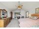 This bedroom has a decorative ceiling fan, fireplace, and large dresser at 8223 Kincross Way, Boulder, CO 80301