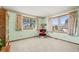 Comfortable bedroom with three large windows, carpet flooring and painted green walls at 8223 Kincross Way, Boulder, CO 80301