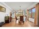 Elegant dining room featuring hardwood floors, large windows, and a stylish chandelier at 8223 Kincross Way, Boulder, CO 80301