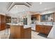 Bright kitchen features oak cabinets, granite countertops, and an island with bar seating at 8223 Kincross Way, Boulder, CO 80301