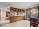 Open-concept kitchen with oak cabinets, glass display cabinets and access to outdoor patio at 8223 Kincross Way, Boulder, CO 80301