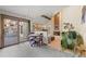 Living room area with sliding glass doors, chandelier, and access to brick fireplace at 8223 Kincross Way, Boulder, CO 80301