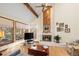 Comfortable living room with hardwood floors, fireplace, and large windows at 8223 Kincross Way, Boulder, CO 80301