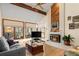 Bright living room offers hardwood floors, vaulted ceilings, and a cozy fireplace at 8223 Kincross Way, Boulder, CO 80301