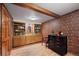 Charming office featuring beautiful built-in bookshelves, striking red wallpaper, and wood floors at 8223 Kincross Way, Boulder, CO 80301