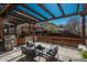 Back patio with a pergola, outdoor furniture and chairs, ideal for relaxing and entertaining guests at 880 E 16Th Ave # D, Denver, CO 80218
