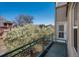 Charming balcony with wrought-iron railings, offering views of mature trees and nearby buildings at 880 E 16Th Ave # D, Denver, CO 80218