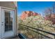 Balcony view overlooking mature flowering trees and a view of an apartment building at 880 E 16Th Ave # D, Denver, CO 80218