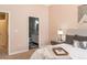 Inviting bedroom with neutral walls, a view of the bathroom, and a cozy bed with decorative pillows and a tray at 880 E 16Th Ave # D, Denver, CO 80218