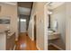 Inviting entryway featuring hardwood floors, a staircase, and a convenient powder room with a vessel sink at 880 E 16Th Ave # D, Denver, CO 80218