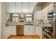 Modern kitchen featuring stainless steel appliances, a kitchen bar, and a gas range with oven at 880 E 16Th Ave # D, Denver, CO 80218