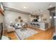 Bright living room featuring hardwood floors, bar seating, and neutral tones, creating an inviting atmosphere at 880 E 16Th Ave # D, Denver, CO 80218