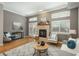 Open concept living area with fireplace, hardwood floors, and abundant natural light from large windows at 880 E 16Th Ave # D, Denver, CO 80218