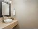 This powder room features a vessel sink with modern faucet, neutral paint, and decorative mirror at 880 E 16Th Ave # D, Denver, CO 80218