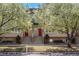 Charming townhome exterior with dual entrances framed by flowering trees and a well-maintained front yard at 880 E 16Th Ave # D, Denver, CO 80218