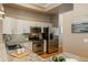 Modern kitchen with stainless steel appliances, granite countertops, and ample cabinet space at 880 E 16Th Ave # D, Denver, CO 80218