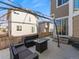 Cozy patio with wicker seating area and a glass-topped fire table perfect for outdoor living at 3155 Kedleston Ave, Highlands Ranch, CO 80126