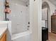 Bright bathroom featuring a combined tub and shower with neutral colors, tile and shelving at 3155 Kedleston Ave, Highlands Ranch, CO 80126