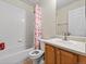 Clean bathroom with a combined shower and tub, vanity with sink and neutral color palette at 3155 Kedleston Ave, Highlands Ranch, CO 80126