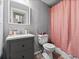Bathroom featuring gray walls and vanity, toilet, and a pastel pink shower curtain at 3155 Kedleston Ave, Highlands Ranch, CO 80126