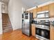 Modern kitchen featuring stainless steel appliances, warm wood cabinets, and hardwood floors at 3155 Kedleston Ave, Highlands Ranch, CO 80126