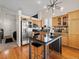 Open kitchen with wooden cabinets, stainless steel appliances, and a central island at 3155 Kedleston Ave, Highlands Ranch, CO 80126