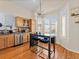 Bright eat-in kitchen features light wood cabinets, stainless appliances, and modern lighting at 3155 Kedleston Ave, Highlands Ranch, CO 80126